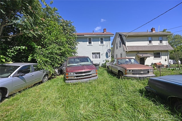 rear view of house with a lawn