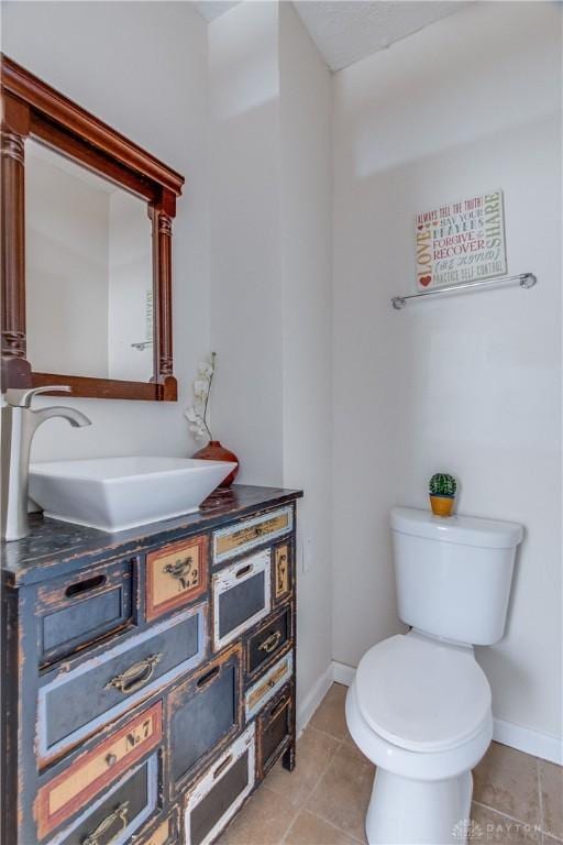 216 S Short St, Troy, OH 45373 - bathroom featuring baseboards, toilet, vanity, and tile patterned floors