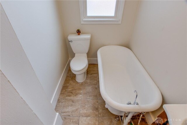 216 S Short St, Troy, OH 45373 - bathroom featuring toilet, baseboards, and a freestanding tub