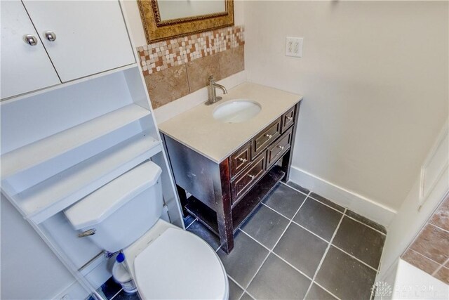 216 S Short St, Troy, OH 45373 - half bath with decorative backsplash, vanity, toilet, and baseboards