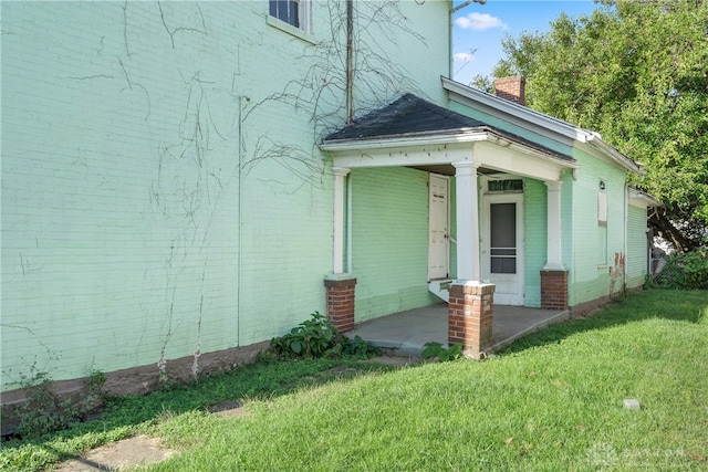 exterior space featuring a porch and a lawn