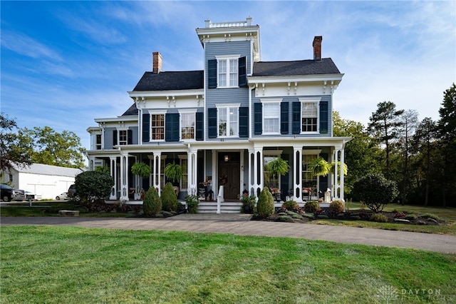 italianate home featuring a front lawn and covered porch