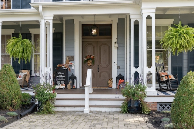 view of exterior entry with covered porch