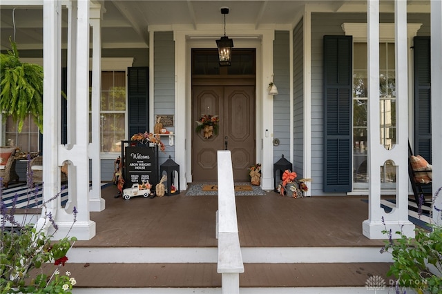 view of exterior entry with covered porch