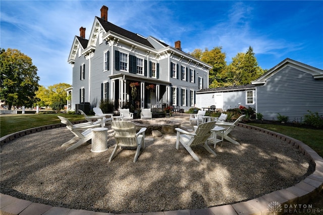 rear view of house with a yard and a patio area