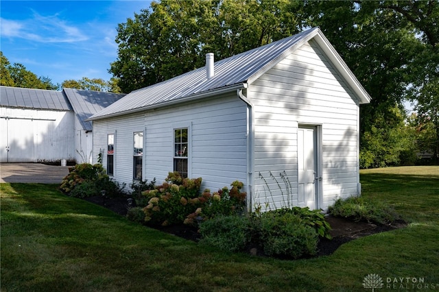 view of side of home featuring a yard