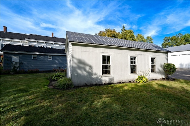 exterior space with a lawn and an outdoor structure