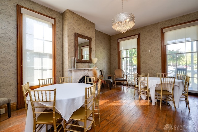 dining space with hardwood / wood-style flooring, a chandelier, and plenty of natural light