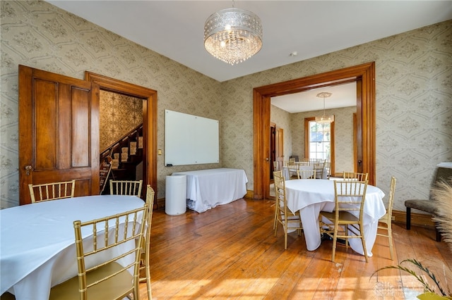 dining room featuring an inviting chandelier and light wood-type flooring