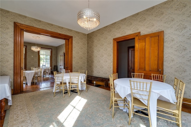 dining room with wood-type flooring and a chandelier