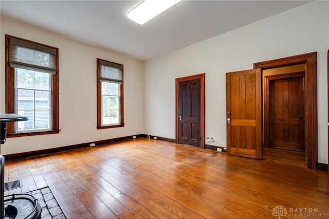 spare room with wood-type flooring