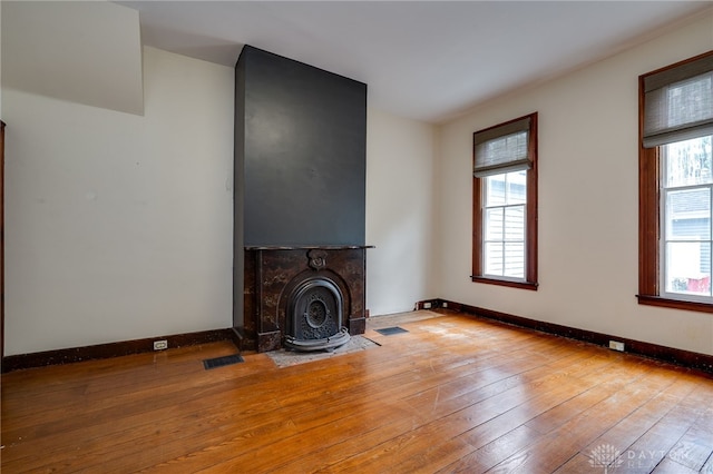 unfurnished living room featuring light hardwood / wood-style flooring and plenty of natural light