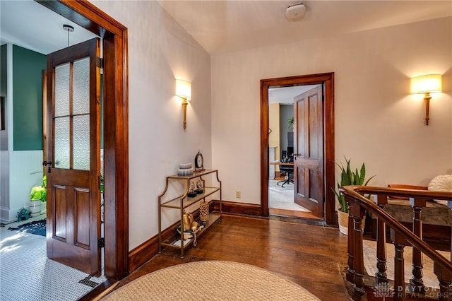 corridor with dark hardwood / wood-style flooring