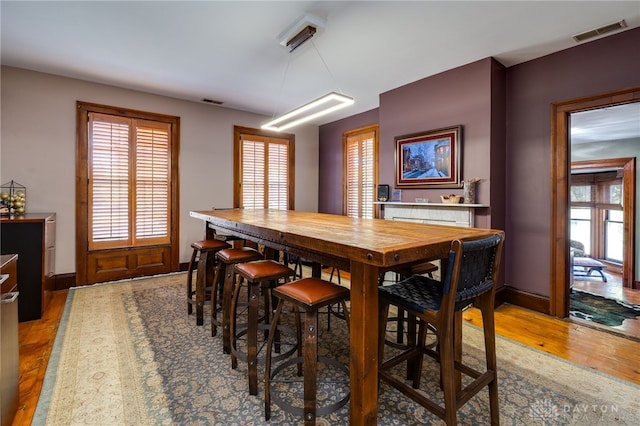 dining space with hardwood / wood-style flooring