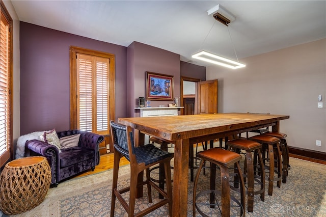 dining room with a healthy amount of sunlight and hardwood / wood-style flooring