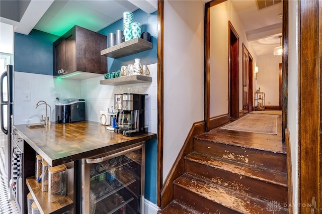 staircase with wine cooler and indoor bar