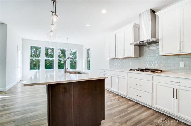 536 Hines Cir, Washington Twp, OH 45458 - kitchen with wall chimney exhaust hood, a sink, stainless steel gas cooktop, light countertops, and recessed lighting