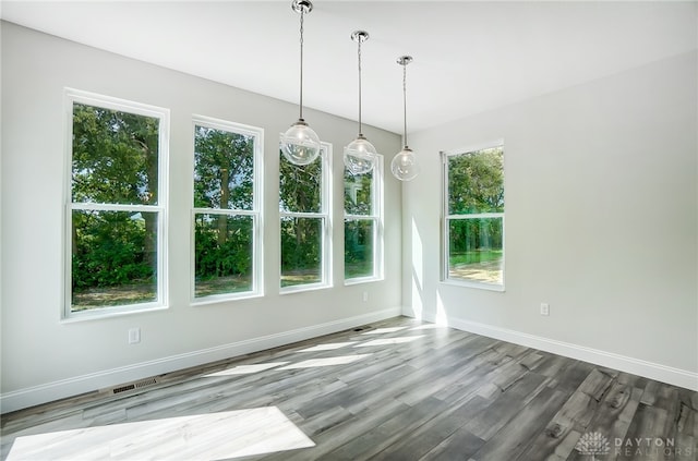 unfurnished dining area featuring hardwood / wood-style flooring