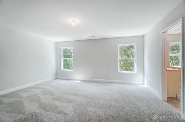 empty room with carpet and plenty of natural light