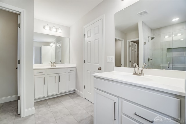 bathroom with a shower with shower door, tile patterned flooring, and vanity