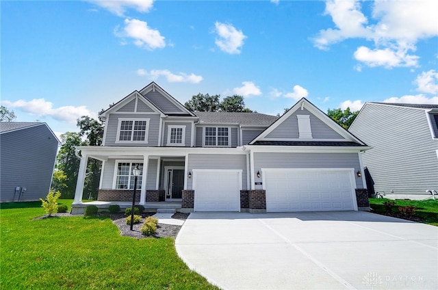 craftsman-style home featuring a garage, a front lawn, and a porch