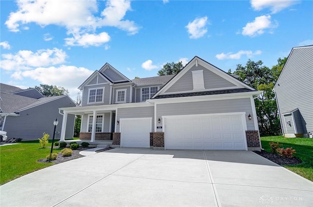 536 Hines Cir, Washington Twp, OH 45458 - craftsman inspired home with brick siding, driveway, a front yard, a porch, and an attached garage