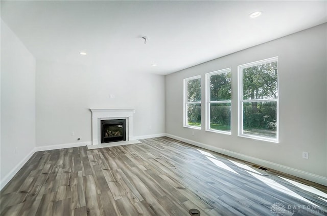 536 Hines Cir, Washington Twp, OH 45458 - unfurnished living room with wood finished floors, baseboards, a fireplace with flush hearth, and recessed lighting