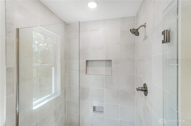 bathroom featuring a shower with shower door