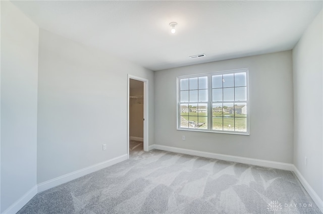 unfurnished room with light colored carpet