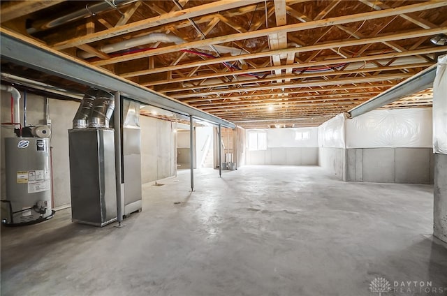 basement featuring water heater and heating unit