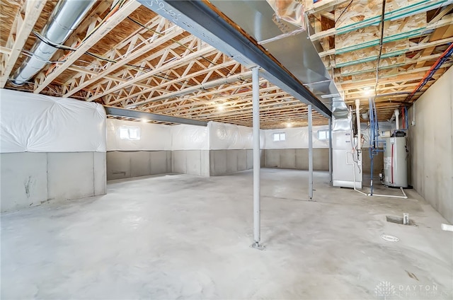 basement featuring heating unit and water heater