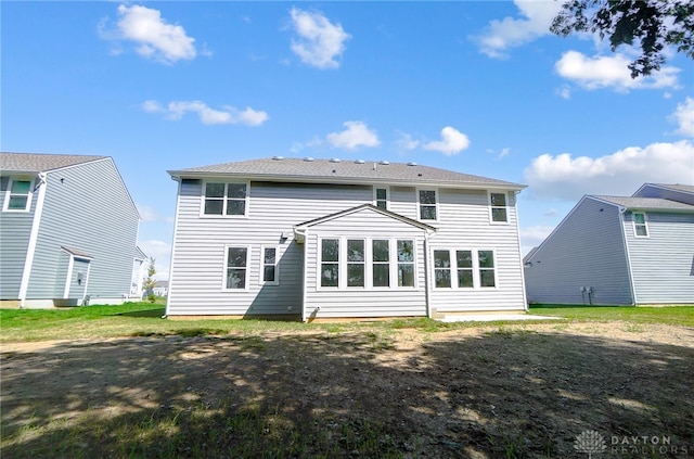 rear view of house with a yard