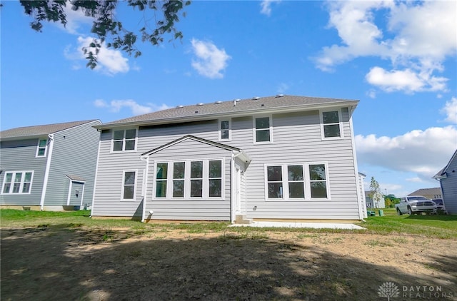 back of house with a lawn