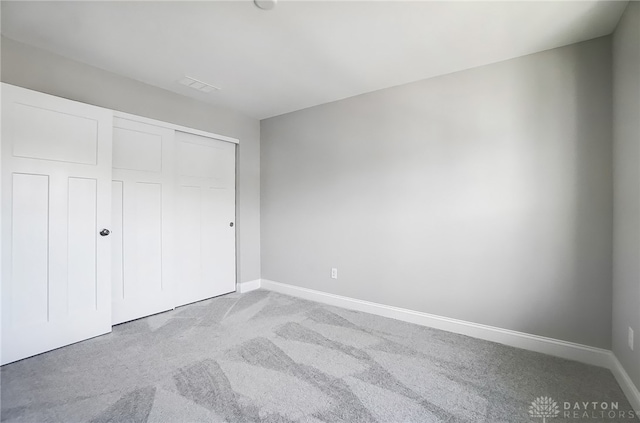 unfurnished bedroom with a closet and carpet