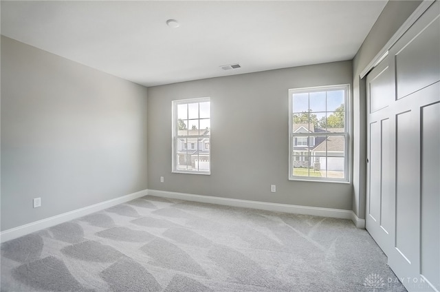 unfurnished bedroom with a closet and carpet floors