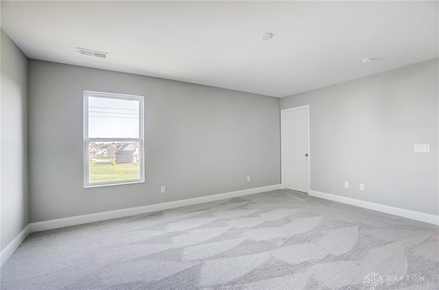 empty room featuring light carpet