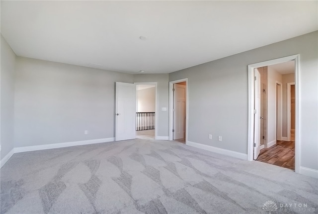 unfurnished bedroom featuring light carpet