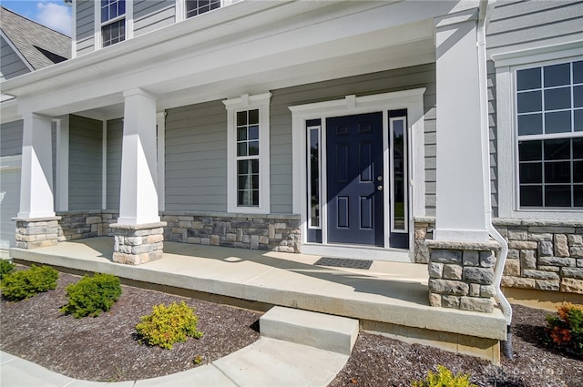 doorway to property featuring covered porch