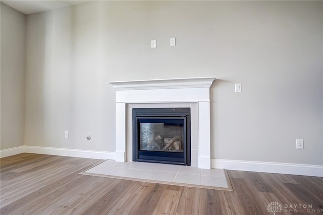 room details featuring a fireplace and wood-type flooring