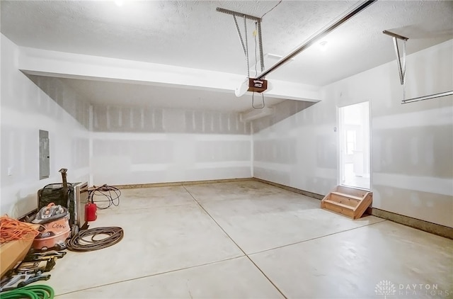 garage with a garage door opener and electric panel