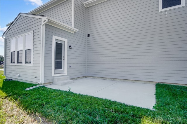 exterior space with a patio and a lawn