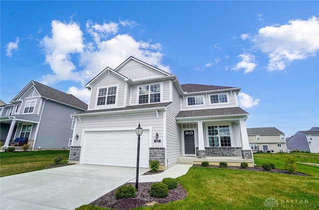 craftsman-style home with a garage, a front lawn, and a porch