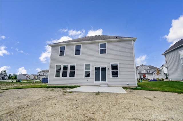 back of property with a patio and a yard