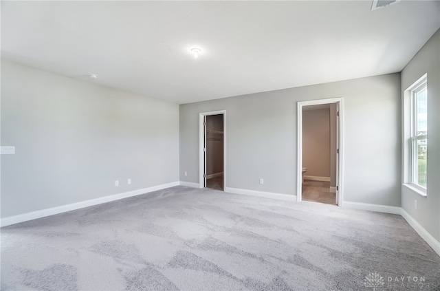 carpeted empty room featuring plenty of natural light