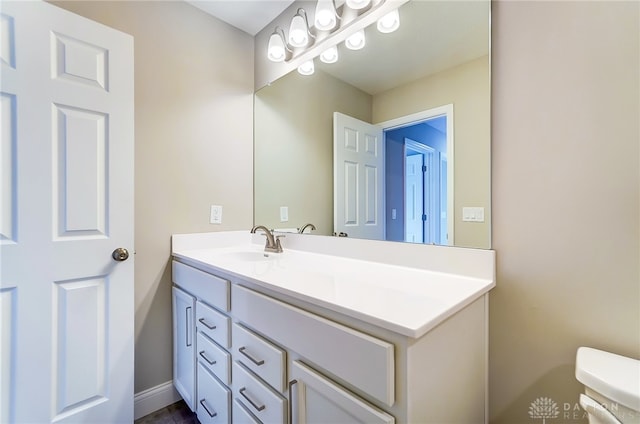 bathroom featuring toilet and vanity