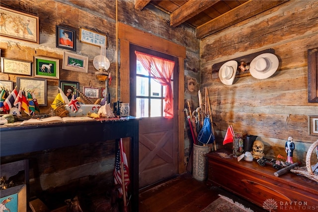 entryway with beam ceiling, hardwood / wood-style flooring, wooden ceiling, and wood walls