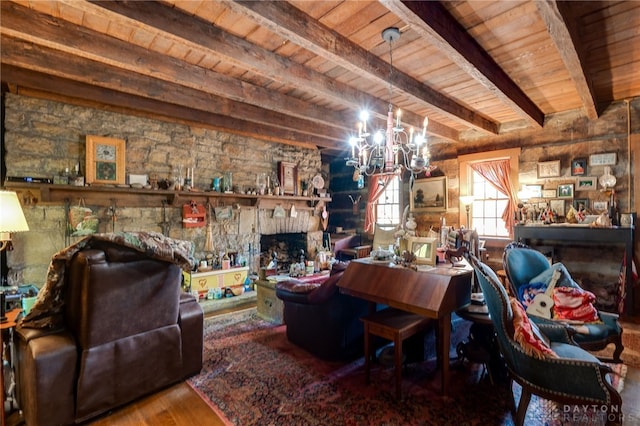 interior space with a stone fireplace, a chandelier, wooden ceiling, beam ceiling, and hardwood / wood-style floors