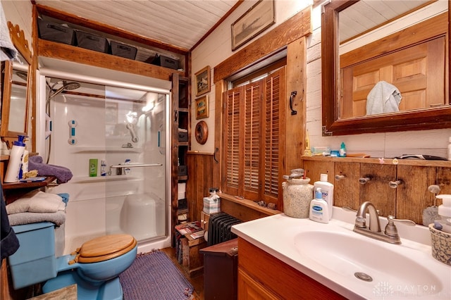 bathroom featuring wood walls, vanity, toilet, a shower with door, and wooden ceiling