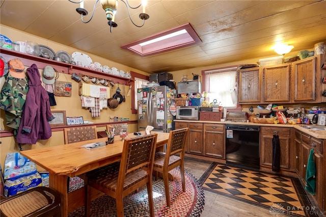 kitchen with sink, a notable chandelier, light hardwood / wood-style flooring, and stainless steel appliances