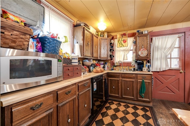 kitchen with plenty of natural light, dishwasher, sink, and wooden ceiling